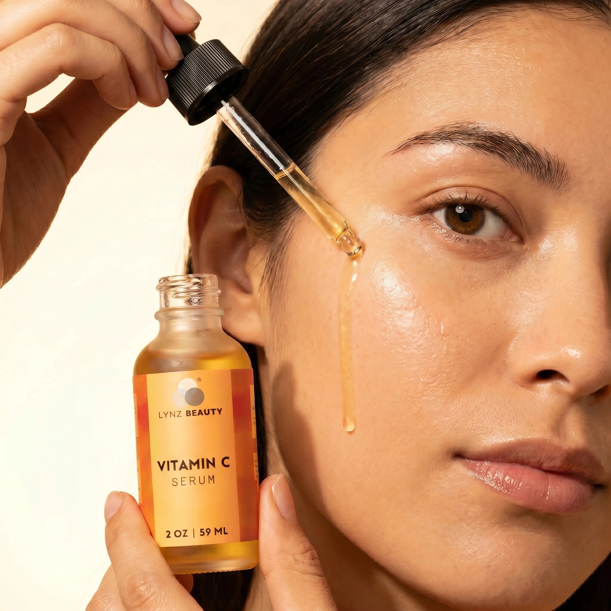 Model applying LYNZ Beauty Vitamin C Face Serum dropper – brightening serum for dark spots and glowing skin